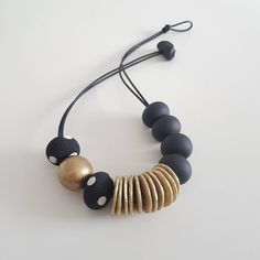 With every order you get a gift. Welcome!🤗 Modern necklace. Necklace that you can wear with jeans or as an elegant evening necklace... Very comfortable to wear. Color: black, gold and one gold wooden bead. Length  cord 55cm, or can be done as much as you want. Dimension beads approx 25mm  Polymer clay and one wooden bead (gold color). Made when ordered. Polymer clay is a relatively new material. For jewelry made of polymer clay, do not act like it's metal or wood jewelry. Clay is durable and el Handmade Black Beaded Necklaces For Everyday, Everyday Black Jewelry With Colorful Beads, Adjustable Black Beads Necklaces For Everyday, Black Beaded Necklace With Colorful Beads, Unique Black Beaded Necklace With Spacer Beads, Adjustable Black Jewelry With Wooden Beads, Large Black Beads For Gifts, Black Wooden Beads Necklace For Jewelry Making, Unique Black Round Beads Necklace