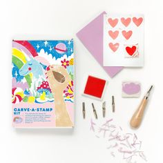 an assortment of crafting supplies including stamps, scissors and paper with hearts on them