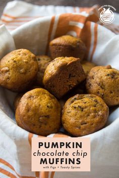 pumpkin chocolate chip muffins in a white bowl with an orange and white striped napkin