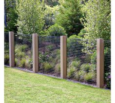 the fence is made out of wood and wire, along with some plants in it