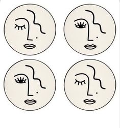 four plates with faces drawn on them in black and white, one has eyes closed