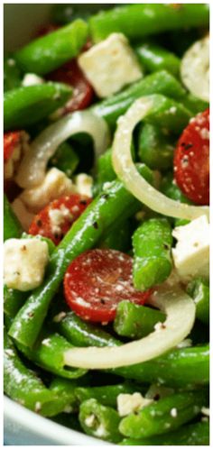 a bowl filled with green beans and tomatoes