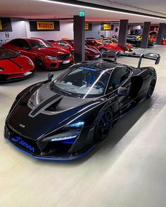 a group of cars parked in a garage next to each other