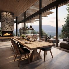 a dining room table with chairs and a fire place in the center, overlooking mountains