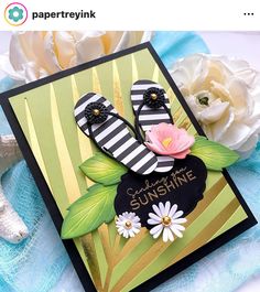 a close up of a greeting card with flowers and sand dollars on the bottom right corner