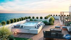 an outdoor patio with couches and tables next to the ocean