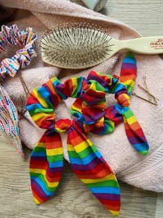 Elevate your hair game with our Stripe Rainbow Scrunchies, a vibrant accessory that adds a pop of color and a sense of pride to your day. This LGBTQAI+ Pride Hair Elastic features a striking rainbow striped design, perfect for showcasing your pride and love for vibrant colors. Whether you prefer a short or long bow, this elastic offers a stylish and practical way to pull back your hair. It's a must-have for rainbow lovers, individuals with long hair, and anyone who adores bright and colorful acc Rainbow Dash Hair, Rainbow Scrunchies, Scrunchies With Bow, Pride Hair, Rainbow Gifts, Long Hair Girls, Rainbow Accessories, Long Bow, Rainbow Keychain