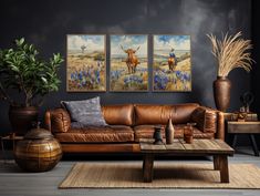 a living room with two paintings on the wall and a couch in front of it