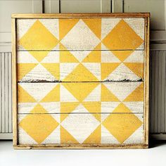 a yellow and white painted chest of drawers