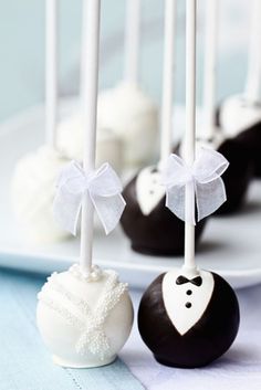 three wedding cake pops are on a plate