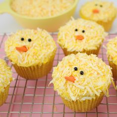 cupcakes with frosting and sprinkles are on a cooling rack