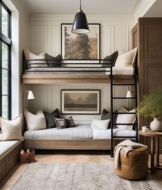 a bunk bed in the middle of a living room with lots of pillows on it