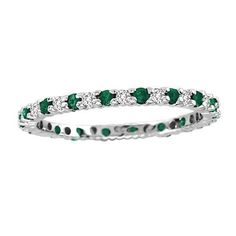 a white gold ring with emeralds and diamonds