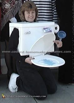 a woman sitting on the ground holding a toilet