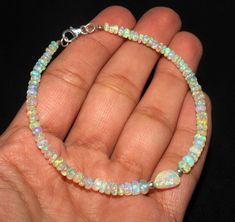 Handmade Ethiopian Opal Elegant Jewelry, Elegant Ethiopian Opal Jewelry With Natural Stones, Opal Gemstone Bracelet Jewelry, Hand-strung Round Opal Jewelry, Adjustable Opal Rondelle Jewelry, Adjustable Hand-strung Opal Jewelry, Elegant Opal Beaded Bracelets With Round Beads, Elegant Handmade Pink Opal Jewelry, Silver Opal Bracelet Gift