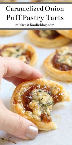 someone is picking up some puff pastry tarts from the baking sheet with text overlay that reads caramelized onion puff pastry tarts