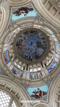 the inside of a large building with many paintings on it's walls and ceiling