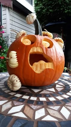 a pumpkin that has been carved to look like a monster with teeth and fangs on it