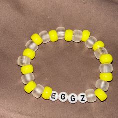 a yellow and white beaded bracelet with numbers on it