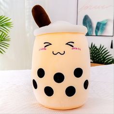 a white and black polka dot pot sitting on top of a bed