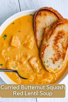 grilled butternut squash red lentil soup in a bowl with two slices of bread