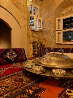 a living room filled with lots of furniture and rugs