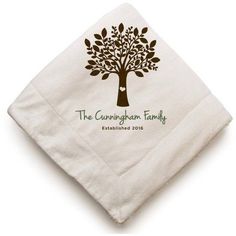 a white napkin with a tree on the front and green lettering that says the countryside family