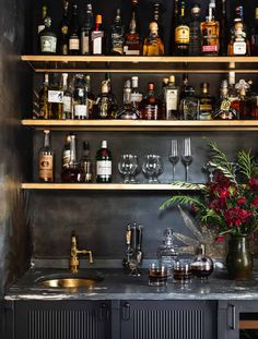 a bar with lots of bottles and glasses on it