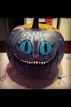 a pumpkin with blue eyes and fangs on it