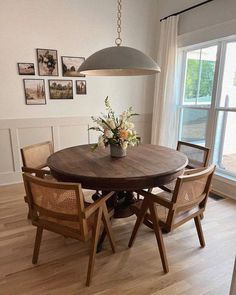 a dining room table with four chairs around it