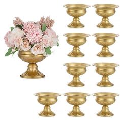 a bunch of gold vases with flowers in them