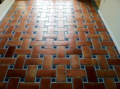 a kitchen floor that is made out of red bricks