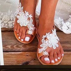 Gorgeous White Lace Flower Flip Flop Sandals Flat Sandals For Spring Wedding, White Closed Toe T-strap Sandals For Spring, Spring Vacation Toe Post Flip Flops, White Flat Heel Sandals For Beach Season, Adjustable Flower Sandals For Spring, Elegant Flat Heel Sandals For Beach Season, Spring Beach T-strap Sandals With Round Toe, Spring Beach Sandals With Single Toe Strap, White T-strap Sandals For Beach