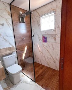 a bathroom with a toilet, sink and shower stall