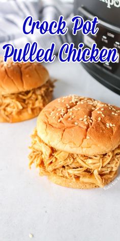 two crock pot pulled chicken sandwiches on top of a white counter with the words crock pot pulled chicken