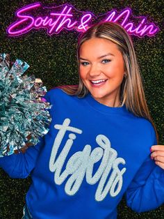 Cheer on your favorite Tigers in style with this cozy, sequins sweatshirt! It comes in a variety of colors so that you can customize the perfect look. Silver glitter trim complete the design, creating an attractive and comfortable piece of clothing that'll be your go-to for everyday wear. Get your hands on one of our best sellers today! Unisex sizing and fit Size: Adult Small - Adult 3XL The sweatshirt is available in many different colors SPECIAL CARE - WASHING INSTRUCTIONS: Hand washing and air drying are always best for these items. Wash on delicate, cold, and inside out. Always air dry to prevent lint from sticking to the letters and for longevity of your beautiful items! Varsity Sweatshirt For Cheerleading In Fall, Winter Long Sleeve Tops For Cheerleading, Fall Sequin Long Sleeve Sweatshirt, Sequin Long Sleeve Sweatshirt For Fall, Sequined Long Sleeve Fall Sweatshirt, White Tigers, Bag Patches, Sequined Sweatshirt, Womens Sweatshirts