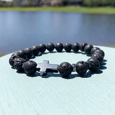 Step into a realm of serenity and spirituality with our 8mm Black Volcanic Rock Christian Beaded Bracelet. Crafted from the earth's raw energy, each volcanic rock bead embodies strength and resilience, providing a grounding foundation for your spiritual journey. At its core, a silver cross symbolizes the timeless grace and guidance found in Christian faith. As you wear this bracelet, allow its presence to anchor your intentions and connect you with the healing power of divine love. With complime Spiritual Lava Stone Stretch Bracelet With Natural Stones, Spiritual Lava Stone Stretch Bracelet Gift, Spiritual Cross Bracelets As Gifts, Symbolic 8mm Bead Bracelet As Gift, Casual Rosary Bracelet With 8mm Beads As Gift, Spiritual Lava Stone Beaded Bracelets With 8mm Beads, Spiritual Lava Stone Bracelets With 8mm Beads, Spiritual Cross Bracelets, Casual Cross Jewelry Gift