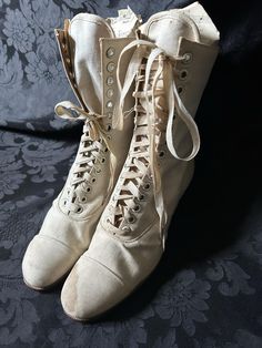 Original white/cream canvas Edwardian boots. Either new/old stock or barely worn. Some water staining, one original bootlace (short)  and one replacement bootlace. Manufacturer- Bedggood Manufacture of boots & shoes Premier (code 3E 575) Quite wearable, good solid condition. Measurements- 10 inches outside heel - toe, 2 inch heel, 3 inches widest width of sole, 9 inch height to top, 8 inch narrowest point at ankle (not inc lacing width), 9 inch leg. Eyelets 14 up (28 in total) These boots would White Riding Boots, Edwardian Boots, White Lace Up Boots, Victorian Shoes, Victorian Boots, Fall Winter Trends, Wedding Boots, Old Fashion Dresses, White Boots