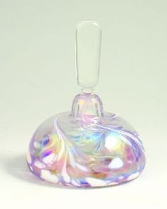 a clear glass vase with an iridescent design on the top and bottom, sitting on a white surface