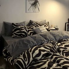 a zebra print comforter on a bed in a bedroom