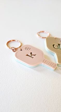 two key chains that are shaped like cats