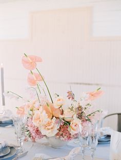 the table is set with flowers and silverware