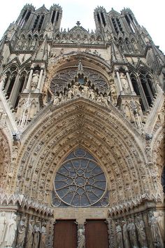 the front entrance to an old cathedral with statues on it