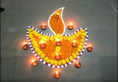 a decorated diya with candles on the ground