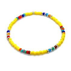 Men's summer bracelet with yellow beads and bright accent beads in assorted colors. Simple stretch bracelet. Yellow Bracelets With Round Beads For Vacation, Colorful Beaded Yellow Bracelets For Vacation, Yellow Beaded Bracelet For Vacation, Multicolor Tiny Beads Bracelets For Beach Season, Multicolor Tiny Beads Bracelet For Beach Season, Yellow Beaded Bracelets For Vacation, Casual Yellow Beads For Beach, Yellow Beaded Bracelets With Colorful Beads For Beach, Yellow Beaded Bracelets For Beach With Colorful Beads