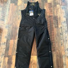 Quilted Bib Coveralls Size 38x32. Lots Of Pockets, Zip And Buttons On Legs. Black Utility Overalls For Workwear, Black Bib Front Utility Overalls, Black Bib Front Overalls For Workwear, Black Utility Overalls With Bib Front, Fitted Black Utility Overalls, Black Fitted Utility Overalls, Winter Workwear Overalls With Pockets, Fitted Winter Overalls With Pockets, Quilted Bib