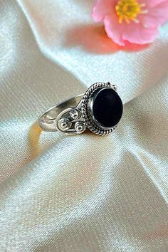 Sanskrit for divine, Divya symbolizes the life energy within us which connects to the divine energy of the universe. Our Divya ring is handcrafted in fine sterling silver, with signature textured detailing and an authentic large solitaire gemstone as a centerpiece, adding sophistication to your everyday look. Authentic Sivalya Black Onyx Hallmarked Metal: 925 Sterling Silver Gemstone Size: 10mm x 10mm Cut: Round Shaped Smooth Cabochon Black Onyx: Endurance, Perseverance, Grounding Spiritual Black Rings, Traditional Black Sterling Silver Rings, Spiritual Onyx Ring Jewelry, Black Spiritual Round Rings, Traditional Black Jewelry With Polished Finish, Spiritual Black Onyx Rings, Black Spiritual Jewelry With Oxidized Finish, Spiritual Black Jewelry With Oxidized Finish, Symbolic Black Rings With Oxidized Finish