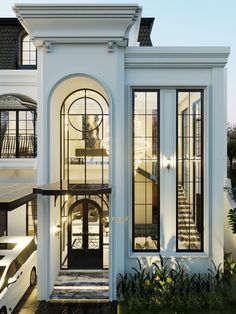 a white house with black trim and glass doors