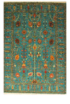 a blue rug with an intricate design on the top and bottom, in various colors