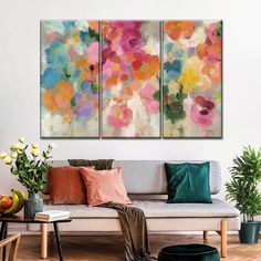 a living room with two paintings on the wall